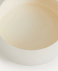 Load image into Gallery viewer, Close-up of a light beige circular object on a white background