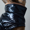 Load image into Gallery viewer, Adjustable waterproof jacket with knit turtleneck and fleece lining. The fleece on the inside keeps your dog warm and comfortable and the knit turtleneck makes the outfit super chic. It is fitted with adjustable velcro straps on the back, black fleece lining for comfort and camel knit turtleneck.