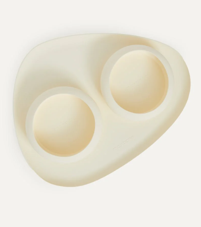 Beige pet bowl and mat silicone set on a white background