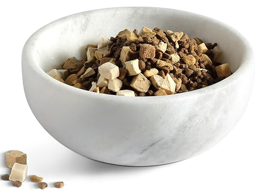 White marble bowl filled with pet food on a white background