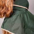 Cargar la imagen en la vista de la galería, The Paramount cape is waterproof, hooded and has 3 lines of snap buttons underneath to adjust the chest and a hole for leash attachment. Perfect for rainy days.
