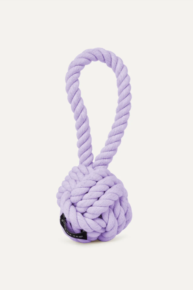Purple rope dog toy with a ball on a white background