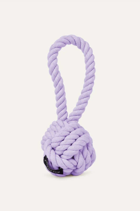 Purple rope dog toy with a ball on a white background