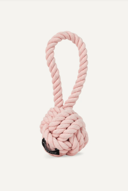 Pink rope knot dog toy on a white background