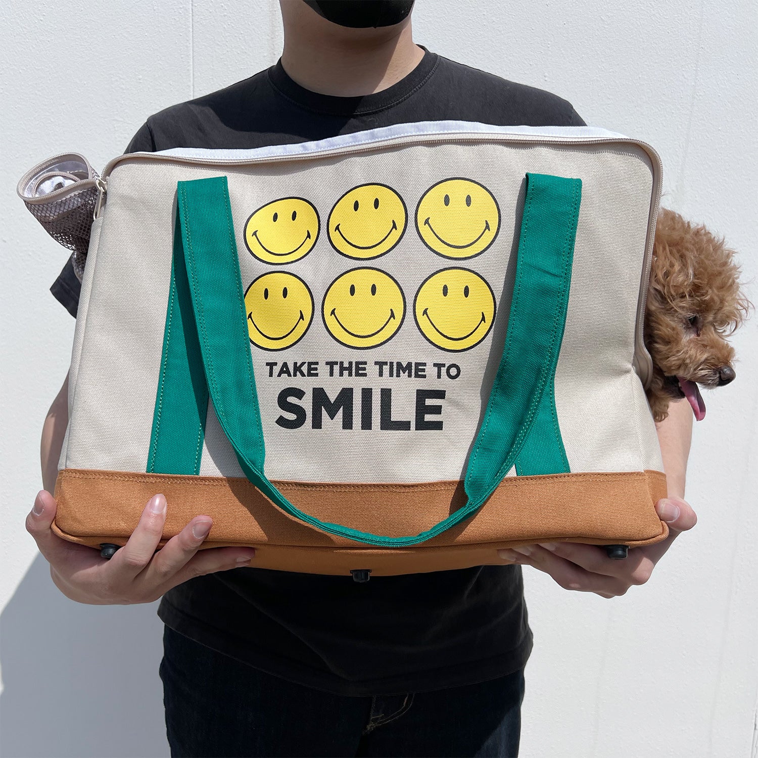 Smiley Dog Carrier. Crafted from 100% cotton canvas and designed with comfort, safety and convenience in mind, this chic carrier allows you to enjoy easy, stress-free outings with your pet.