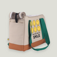 Load image into Gallery viewer, Smiley Dog Carrier. Crafted from 100% cotton canvas and designed with comfort, safety and convenience in mind, this chic carrier allows you to enjoy easy, stress-free outings with your pet.
