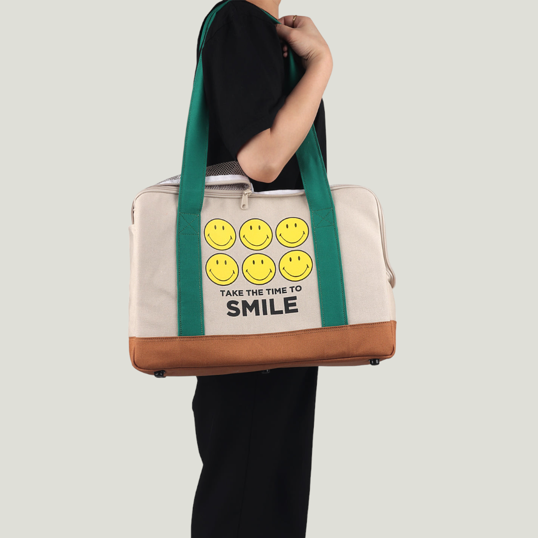 Smiley Dog Carrier. Crafted from 100% cotton canvas and designed with comfort, safety and convenience in mind, this chic carrier allows you to enjoy easy, stress-free outings with your pet.