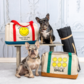 Load image into Gallery viewer, Smiley Dog Carrier. Crafted from 100% cotton canvas and designed with comfort, safety and convenience in mind, this chic carrier allows you to enjoy easy, stress-free outings with your pet.
