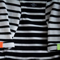 Load image into Gallery viewer, Striped, black & white T-shirt made with a stretchy fabric, black ribbed details and a color detail on the sleeves. Comfortable and easy to wear, perfect for summertime.
