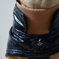 Load image into Gallery viewer, Adjustable waterproof jacket with knit turtleneck and fleece lining. The fleece on the inside keeps your dog warm and comfortable and the knit turtleneck makes the outfit super chic. It is fitted with adjustable velcro straps on the back, black fleece lining for comfort and camel knit turtleneck.
