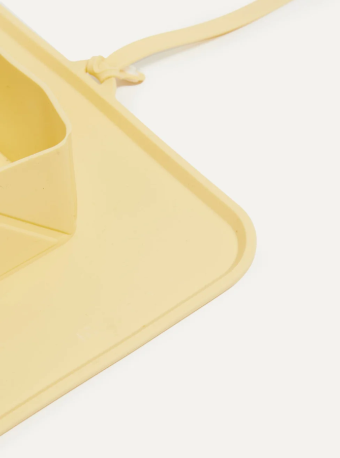 Yellow green silicone on the go (travel) pet bowls on a white background