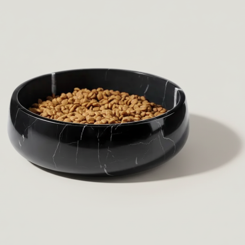 Black marble-patterned pet bowl filled with kibble