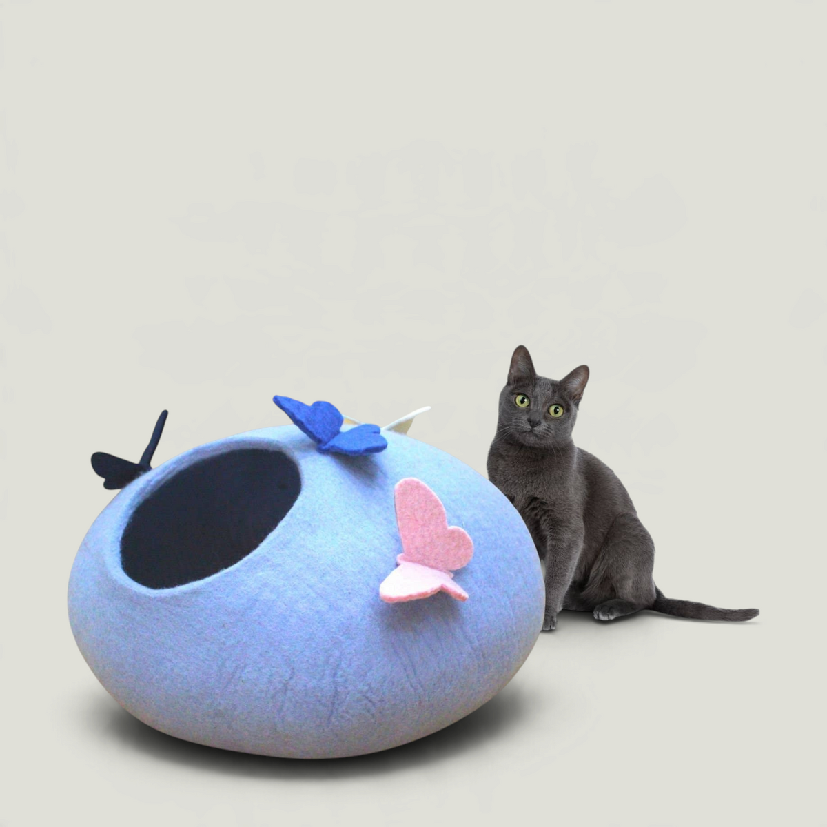 Nala's Pet Furniture Boutique handmade light blue wool felt cat cave bed with decorative butterfly accents and a cat